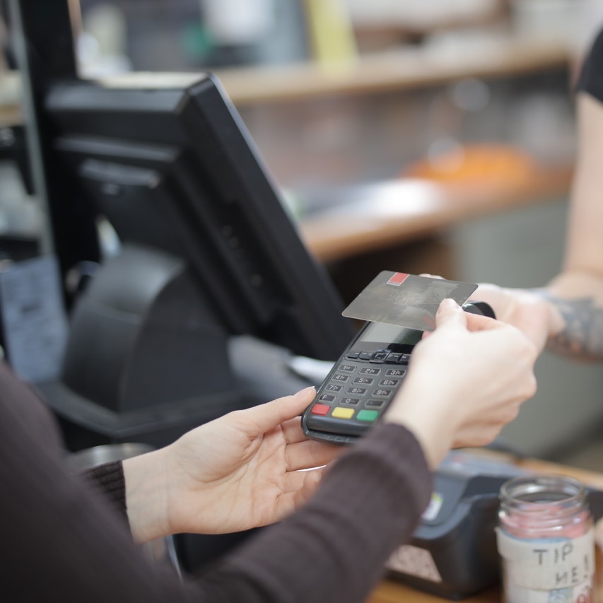 Paying at the cashier, photo by Andrea Piacquadio on Pexels