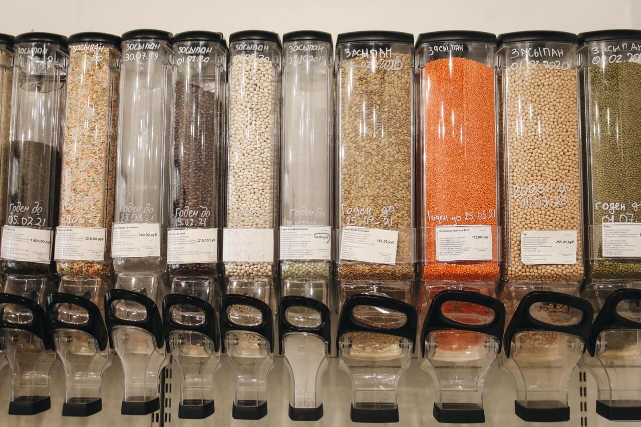 Grains in containers at the shop, photo by Polina Tankilevich on Pexels.
